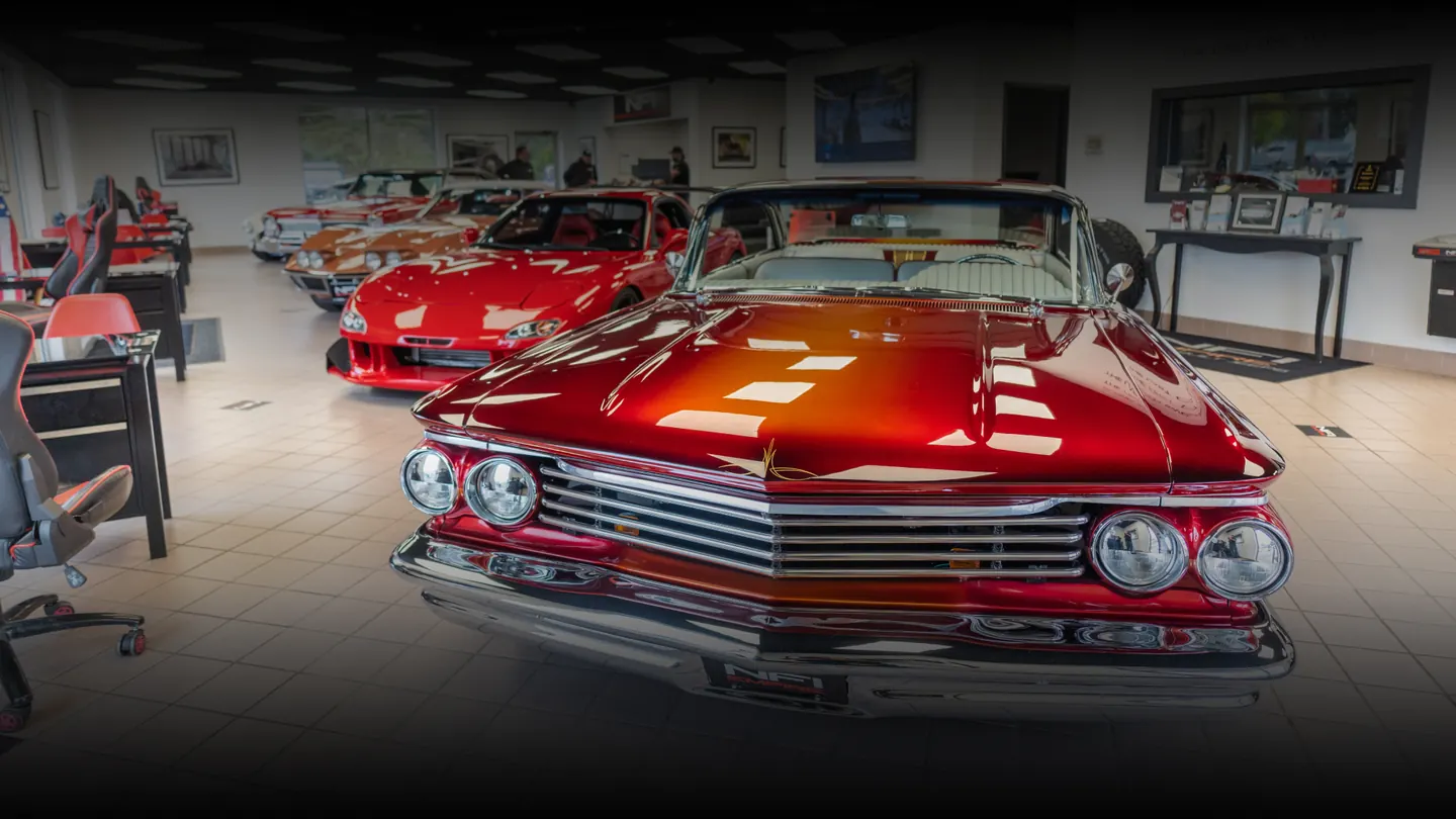 The NFI Empire showroom in North East, PA, a candy-red custom Chevy up front and more classics behind