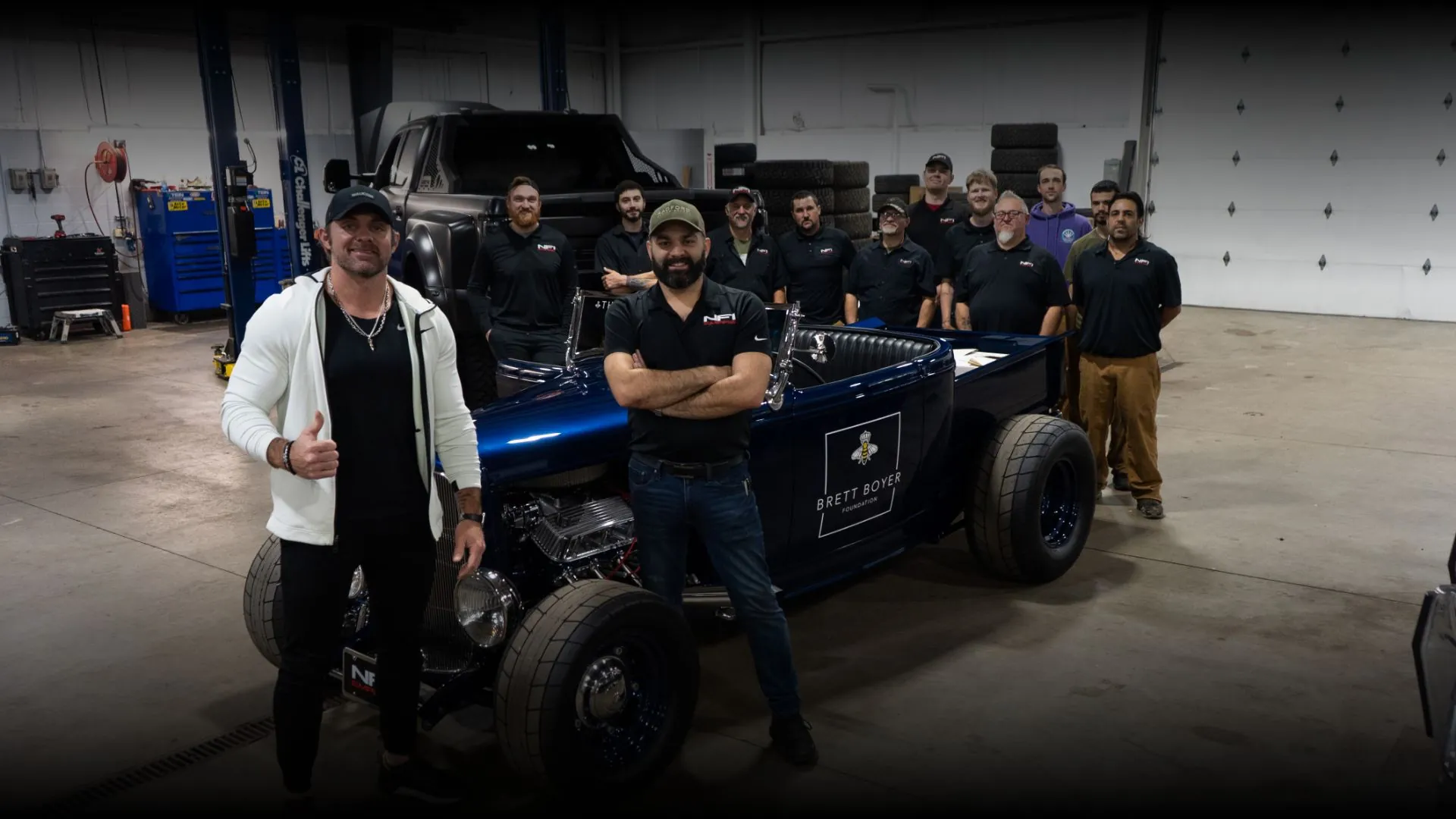 The NFI Empire team around the 1932 Ford roadster charity build in the shop