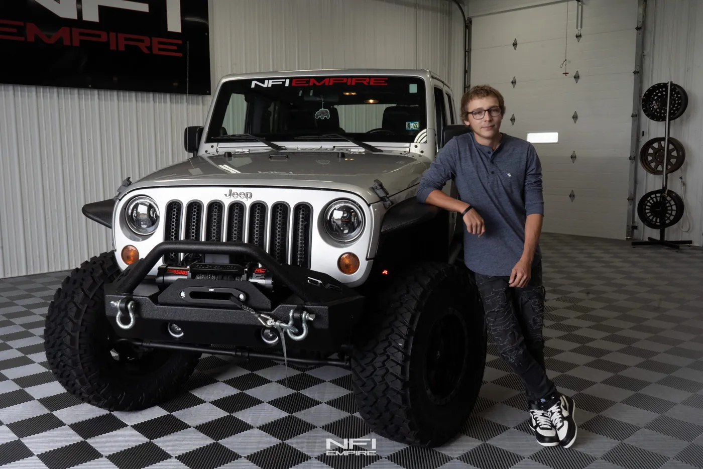 The finished Make-A-Wish Jeep Wrangler with the young man it was built for